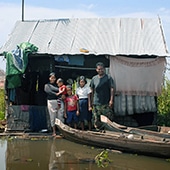 MAIN CASE STUDY FAMILY, MECHREY FLOATING VILLAGE. VIBOL KET WITH NINE MONTH OLD DAVID TUY, TAN TUY, 8, KEO TUY, 11 AND HUSBAND TIN OM, 31,11/10/12. PHOTOGRAPHER CLARE KENDALL.
